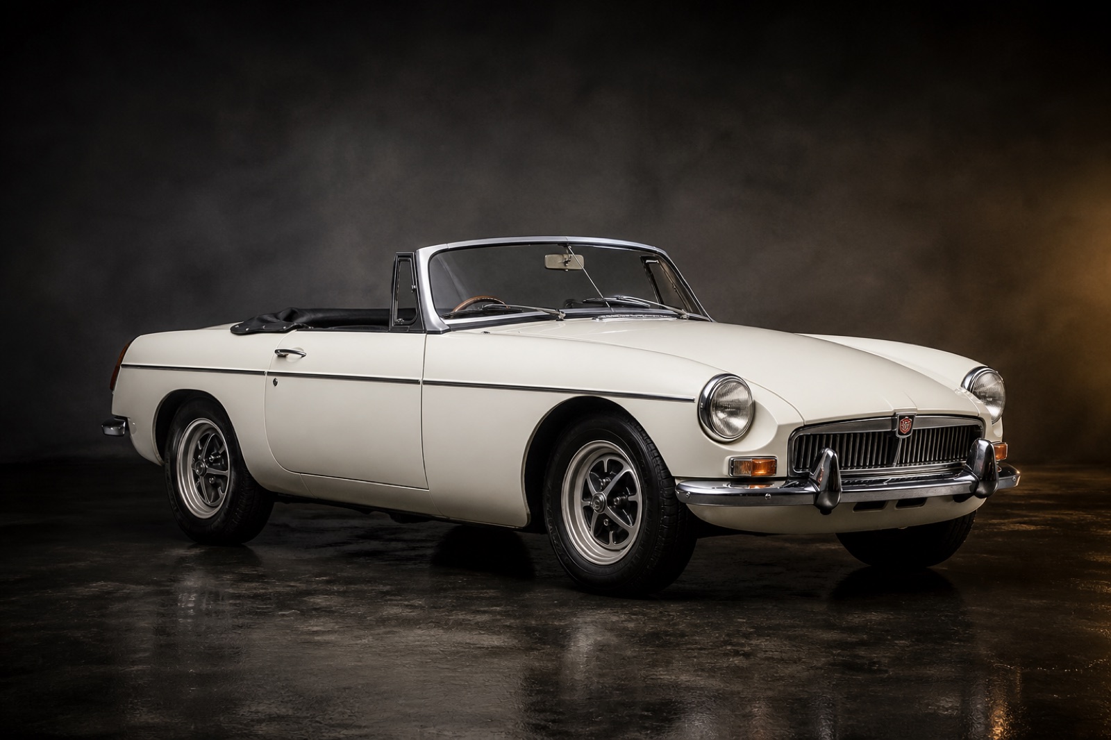 White (Rostyle wheels) MGB Roadster in a dark photographic studio