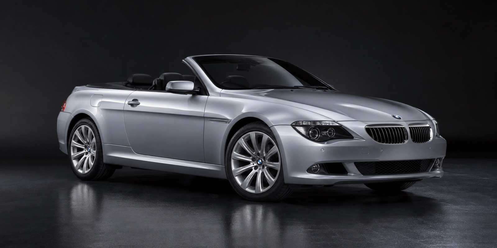 Silver BMW 635d Convertible in a dark photographic studio